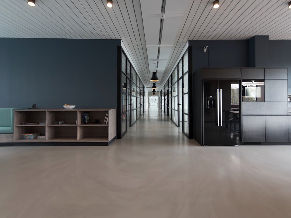 Modern office workspace with desks, monitors and natural light
