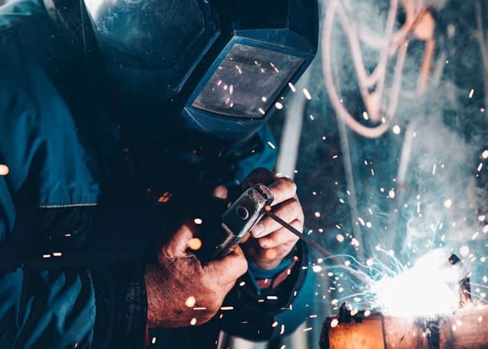 Technician working on equipment with tools at a service site